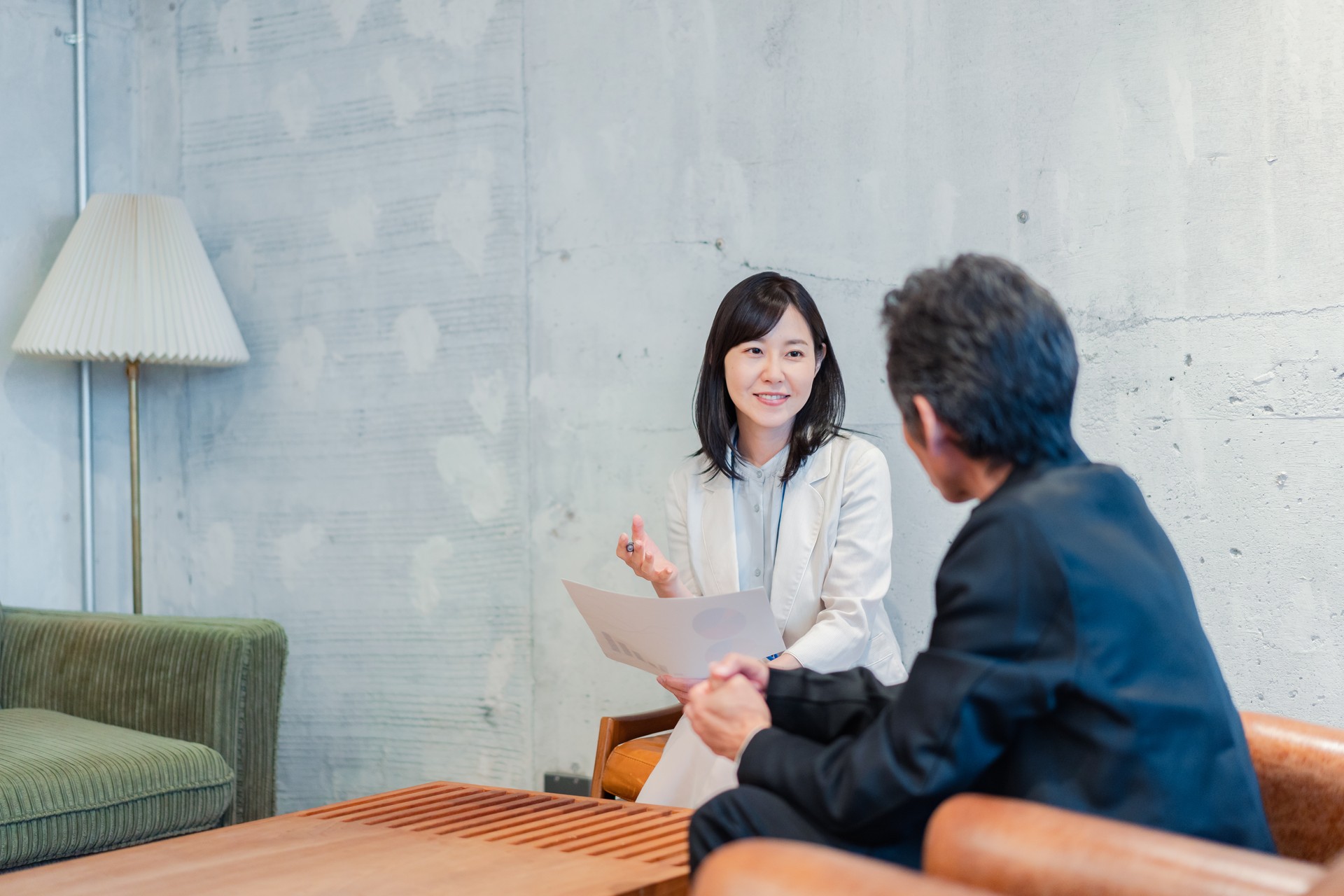 A saleswoman soliciting insurance for a businessman